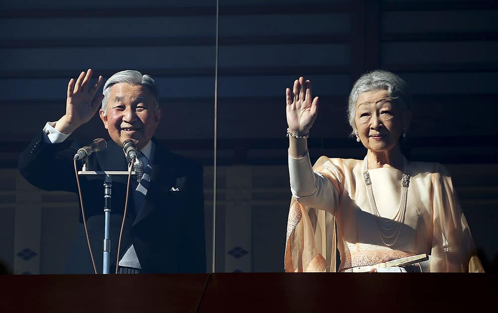 Japan's Emperor Akihito, accompanied by his wife Empress Michiko, wave at well-wishers as they appear on the balcony of the Imperial Palace to mark the emperor's 81th birthday in Tokyo.