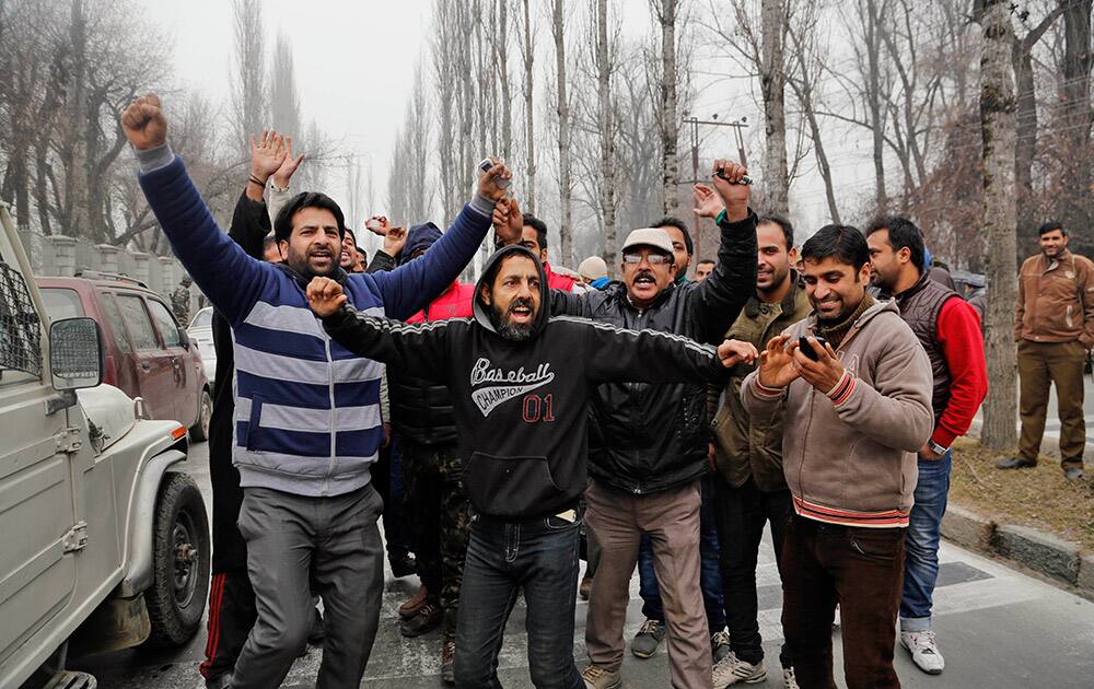 Kashmiri supporters of People's Democratic Party (PDP) celebrate the news of early election result trends outside a counting centre in Srinagar.