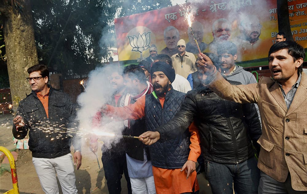 BJP supporters burst crackers as they celebrate partys victory in J&K and Jharkhand Assembly polls, at BJP headquarters in New Delhi.