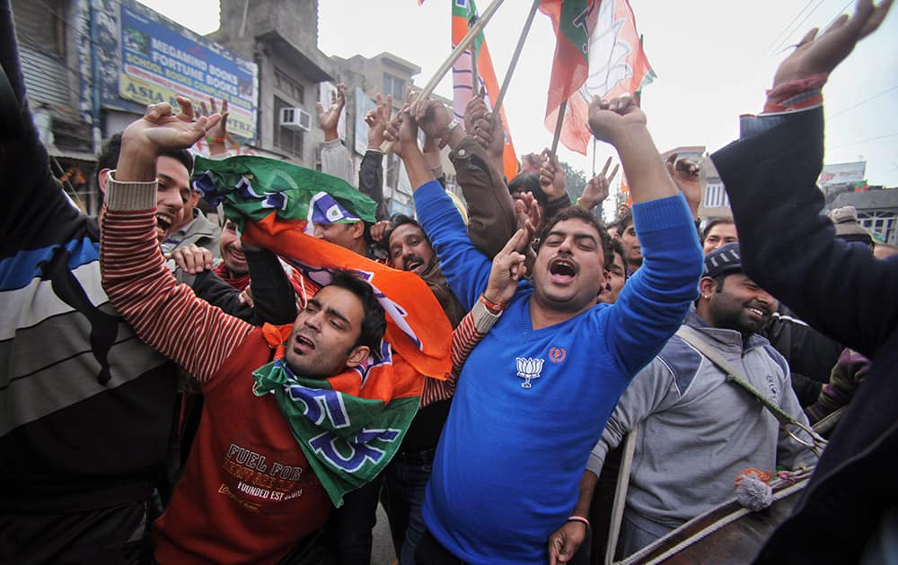 BJP supporters dance to celebrate the news of early election result trends outside their party headquarters in Jammu.