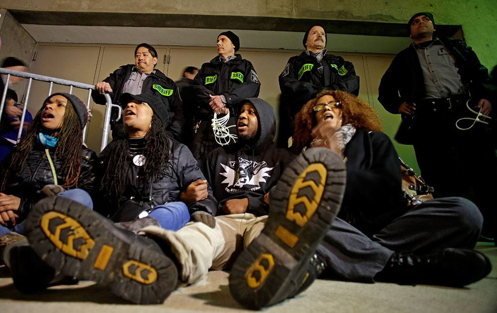 Protesters yell outside the Bradley Center before an NBA basketball game between the Milwaukee Bucks and the Charlotte Hornets in Milwaukee. 