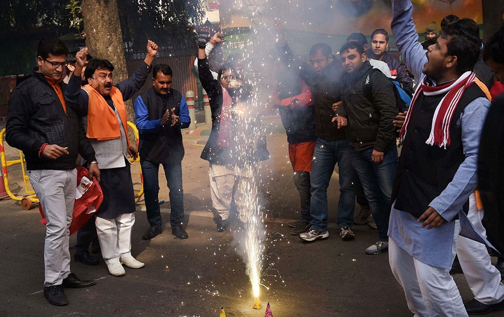 BJP supporters burst crackers as they celebrate partys victory in J&K and Jharkhand Assembly polls, at BJP headquarters in New Delhi.