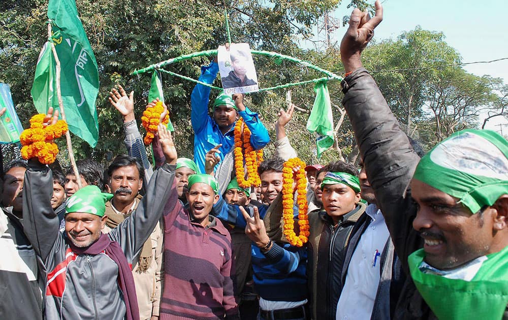 JMM supporters celebrate their party's candidate Amit Mahto win in Jharkhand Assembly polls in front of polling counting, in Ranchi.