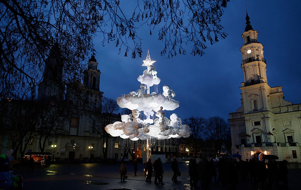 People stroll around a Christmas tree in the Old city in Kaunas, Lithuania.