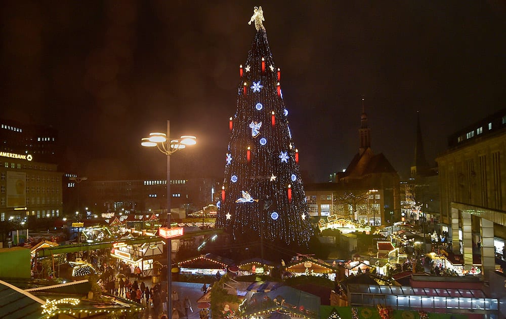 Germany's biggest Christmas is illuminated in the rain at a Christmas market in Dortmund, Germany.