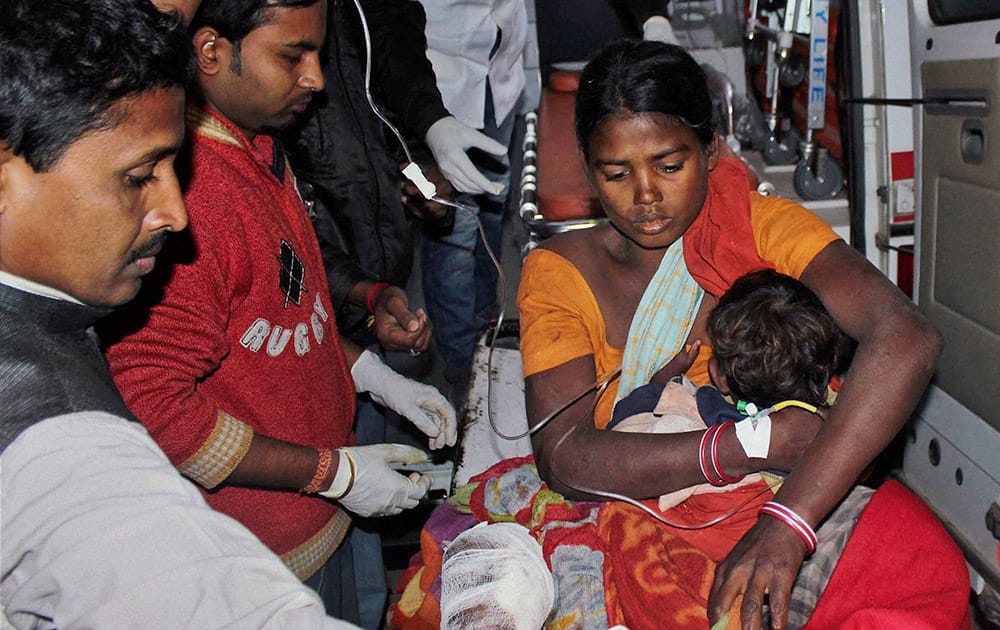 An injured woman and her child are carried in an ambulance to a local hospital in Sonitpur district in India’s northeast state of Assam.