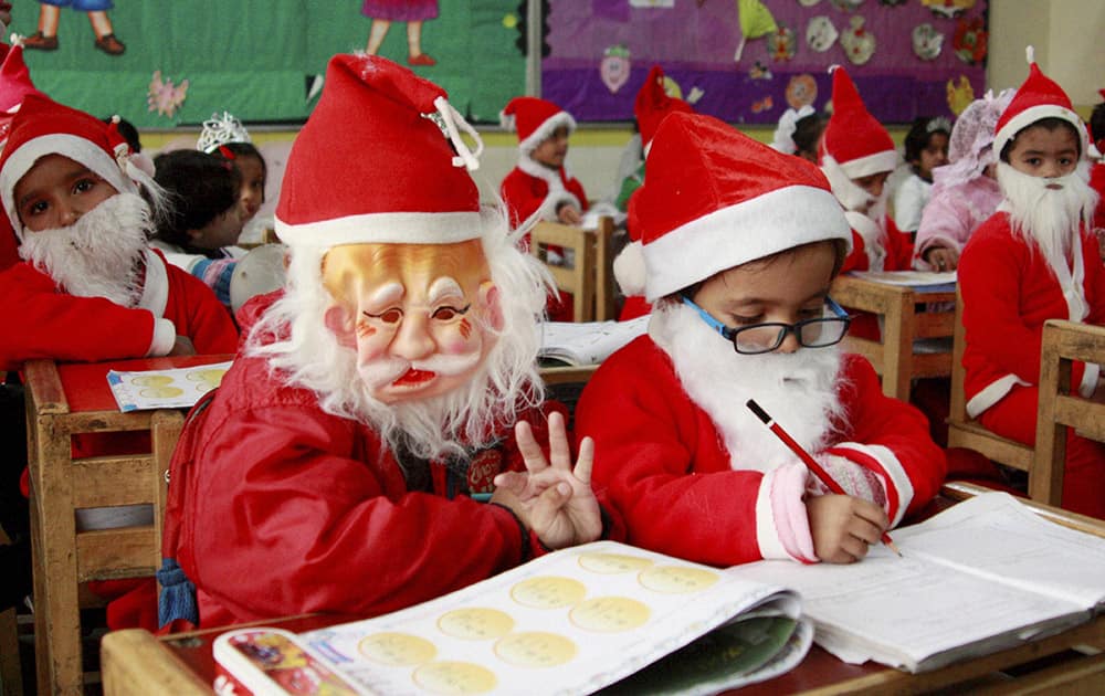 School students dressed as Santa Claus ahead of Christmas day celebrations, in Gurgaon.