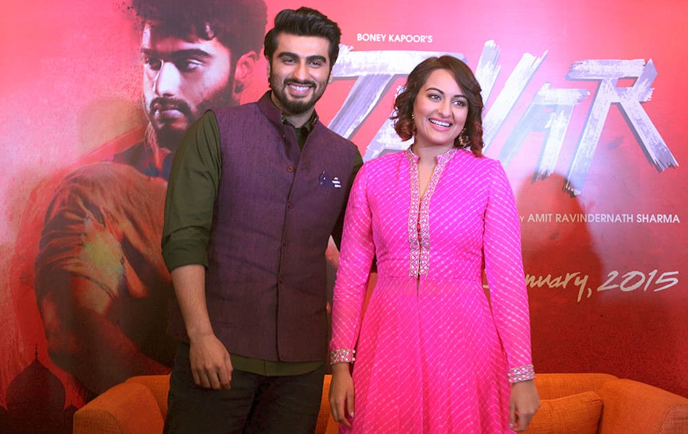 Bollywood actors, Arjun Kapoor and Sonakshi Sinha, smile as they pose for photographers during a press conference to promote their upcoming film 'Tevar' or 'Attitude' in Ahmedabad.