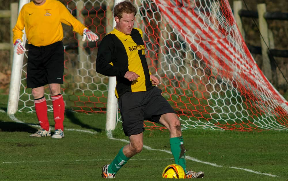 Britain's Prince Harry controls the ball during the annual soccer match between Sandringham estate workers and villagers from neighbouring Castle Rising in Norfolk eastern England.