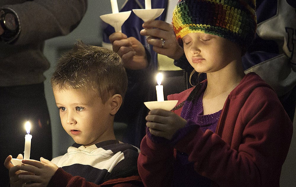 Gary Redfern and Garyn Redfern participate in the Candlelight Communion Service at the Fountain Avenue United Methodist Church in Paducah, Ky. on Christmas Eve night.