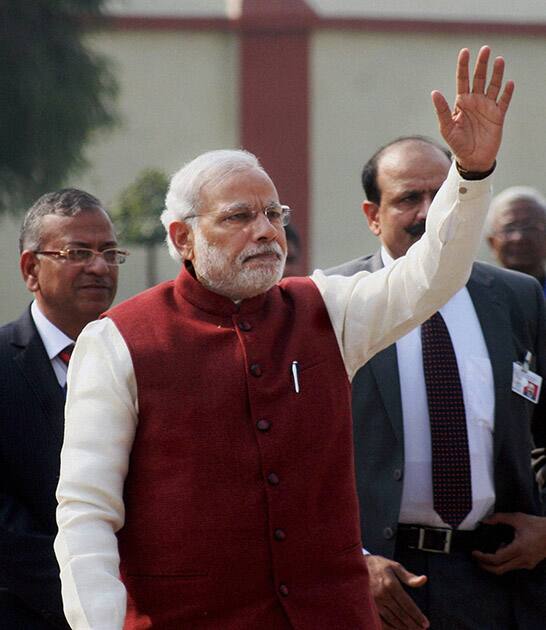 Prime Minister Narendra Modi waves after paying floral tribute to the statue of Madan Mohan Malaviya.