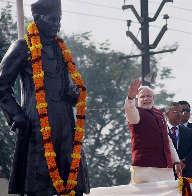 Prime Minister Narendra Modi waves after paying floral tribute to the statue of Madan Mohan Malaviya.