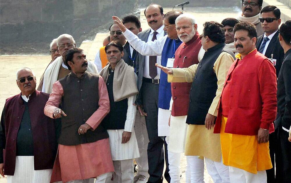 Prime Minister Narendra Modi interacts with the officials during a cleanliness drive at Assi Ghat.