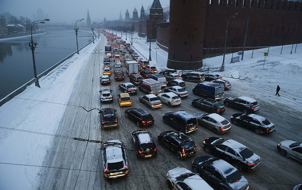 Cars are stuck in a congested traffic on both banks of the Moskva River outside the Kremlin, during heavy snowfall in downtown Moscow.