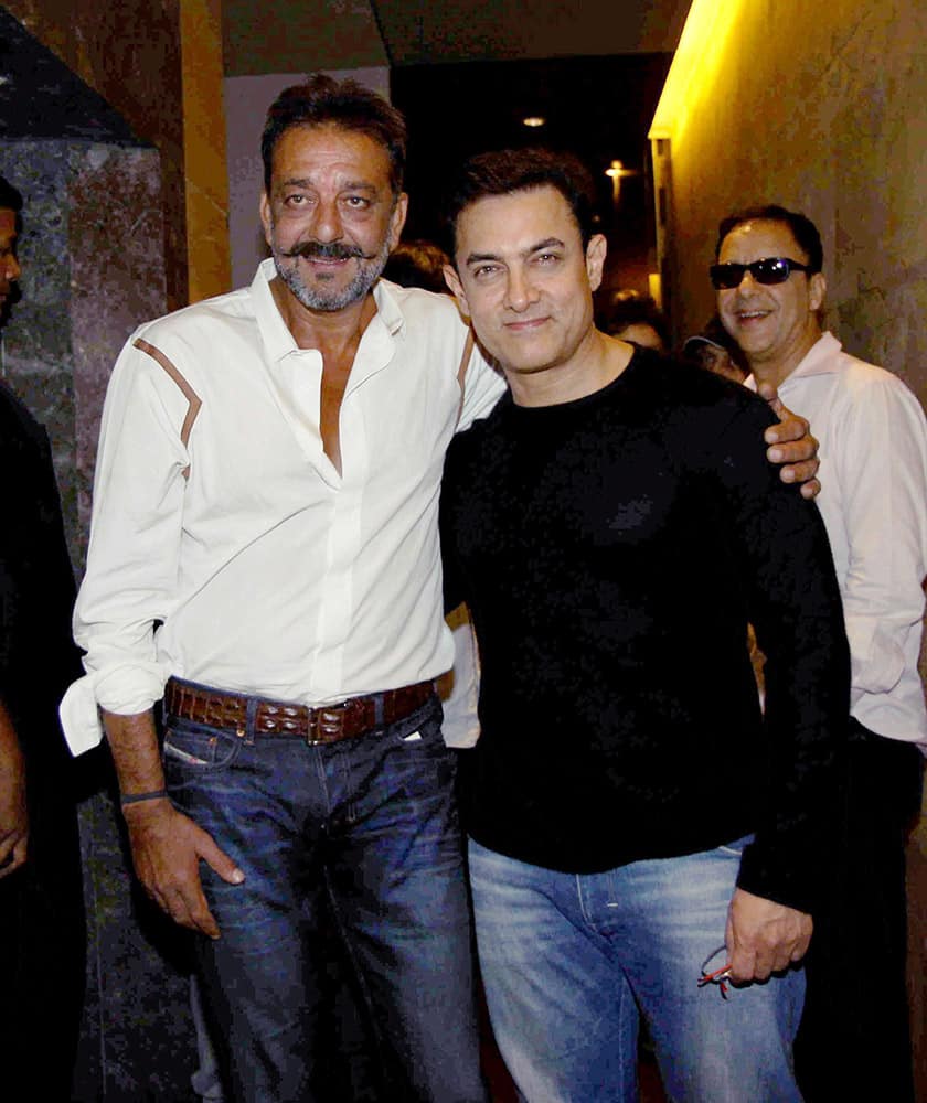 Bollywood actor Aamir Khan and Sanjay Dutt pose together at the special screening of PK in Mumbai.