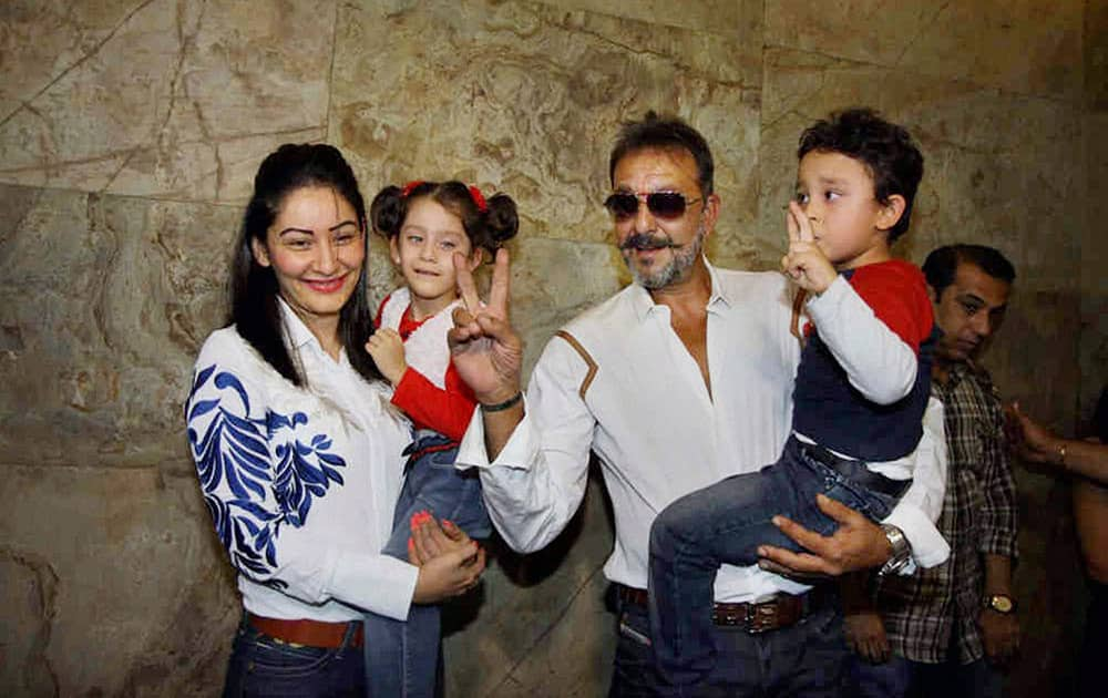 Bollywood actor Sanjay Dutt with wife Manyata Dutt, daughter Iqra and son Shahraan at the special screening of film PK in Mumbai.