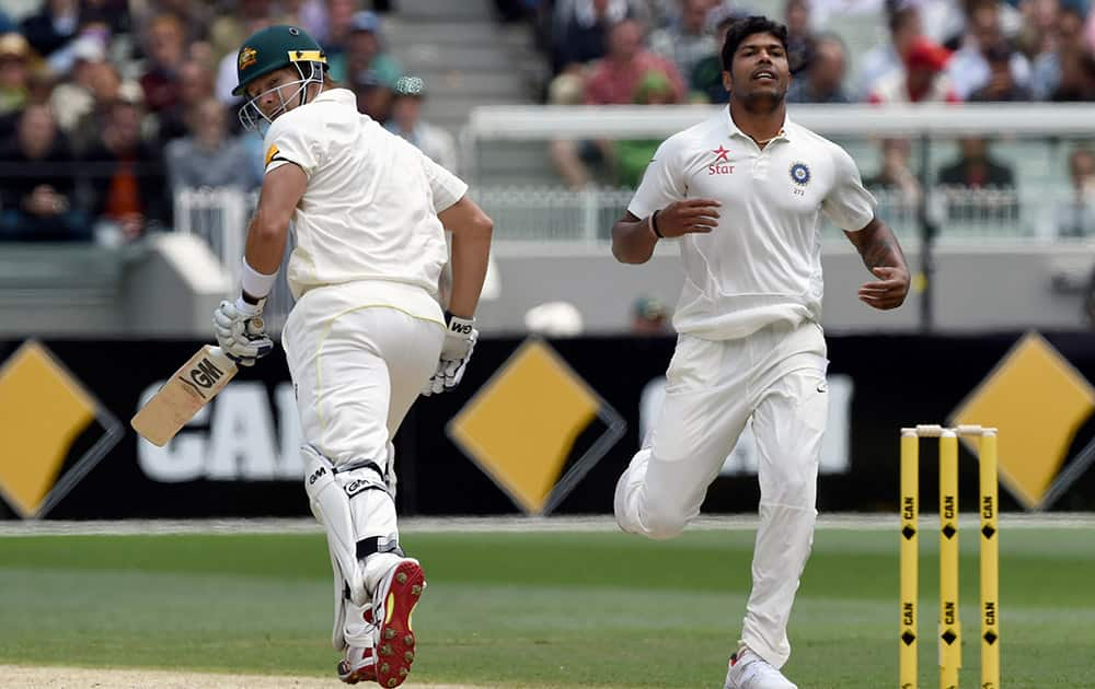 Australia's Shane Watson, takes a run off the bowling of Umesh Yadav, of India during their play on day one of the third cricket test in Melbourne.