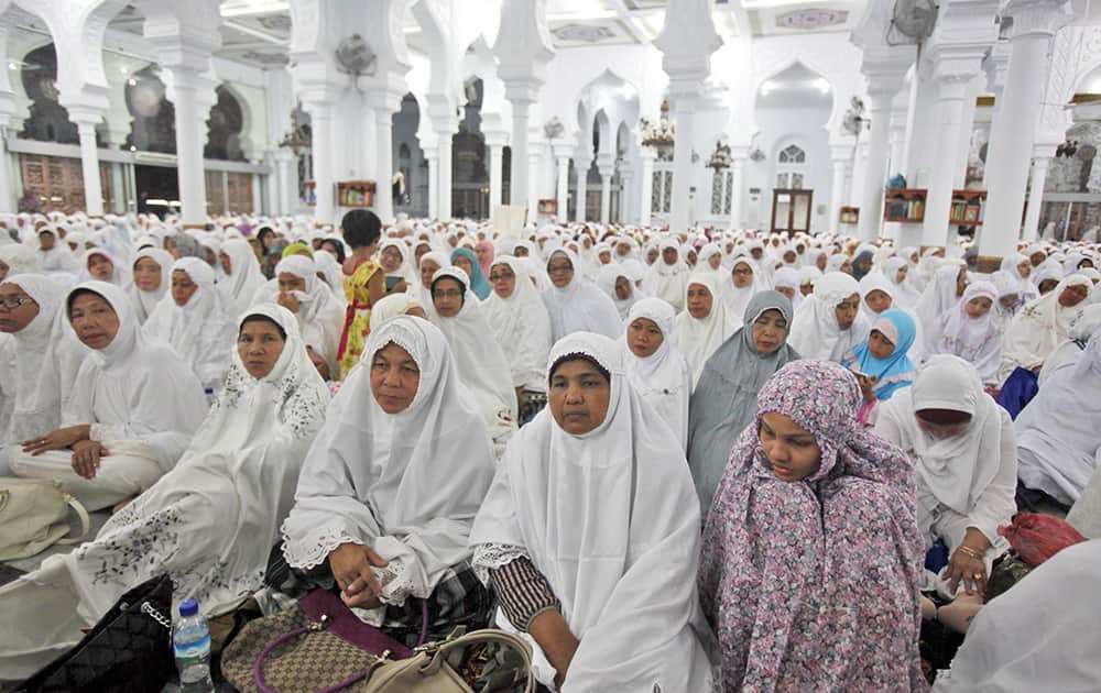 Acehnese women attend a prayer for the victims of Indian Ocean tsunami ahead of its 10th anniversary at Baiturrahman Grand Mosque in Banda Aceh, Aceh province, Indonesia.