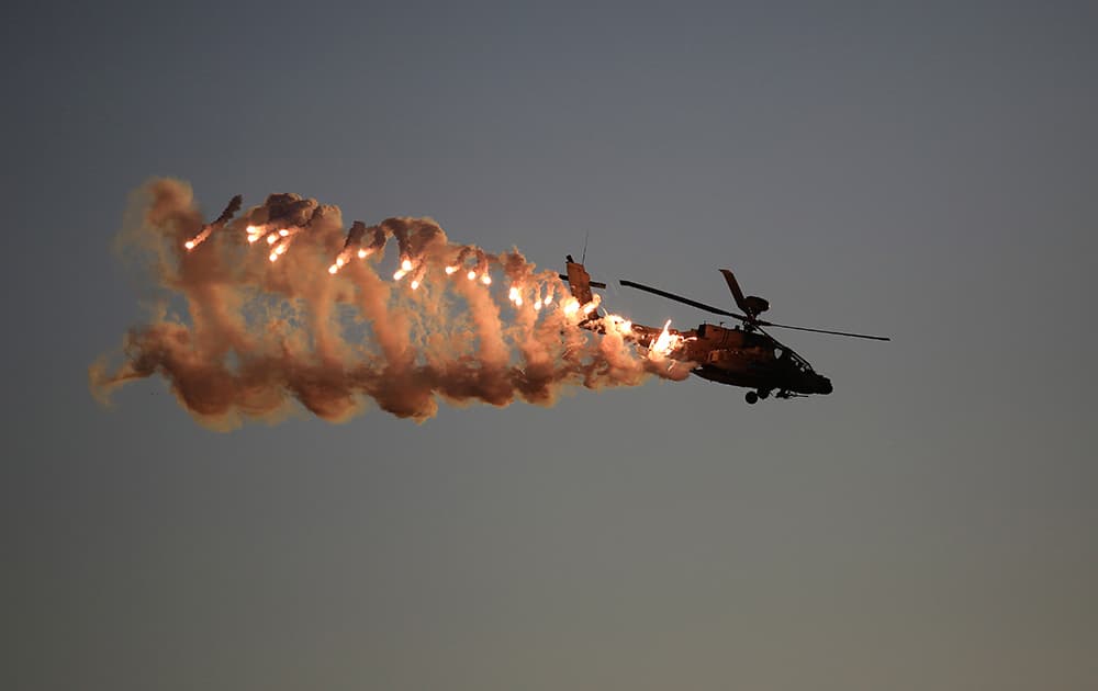 An Israeli Air Force Apache helicopter releases flares during a graduation ceremony for new pilots in the Hatzerim air force base near the city of Beersheba, southern Israel.