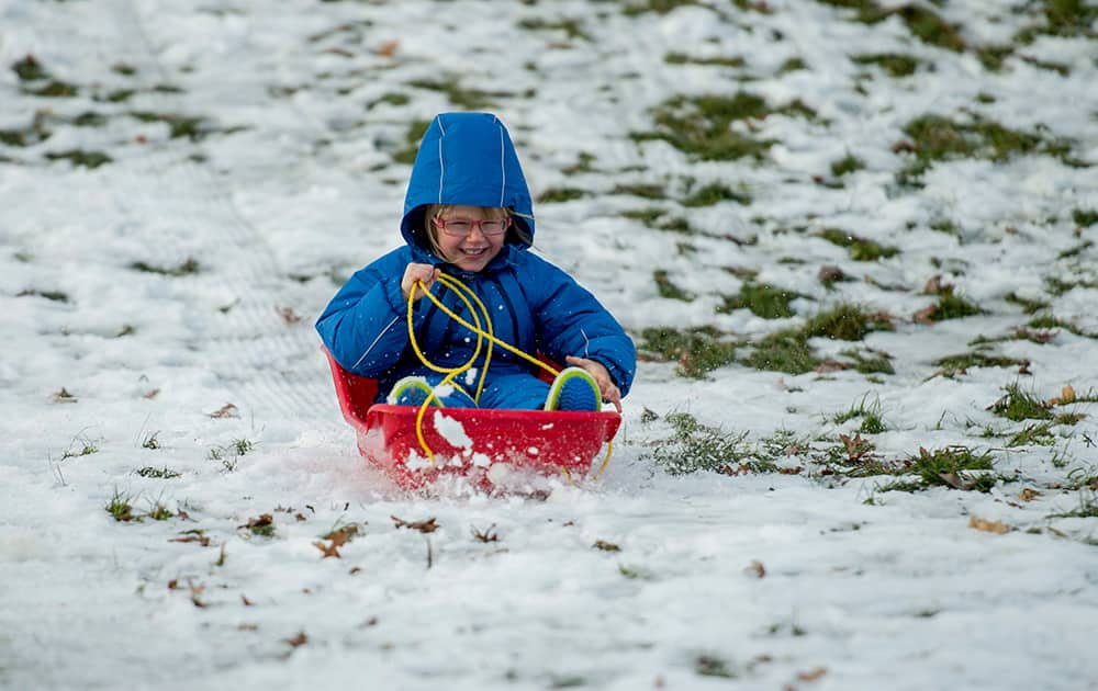 Matilda Green, 4, rides a sled in the Arboretum on Christmas in Ottawa, Ontario.