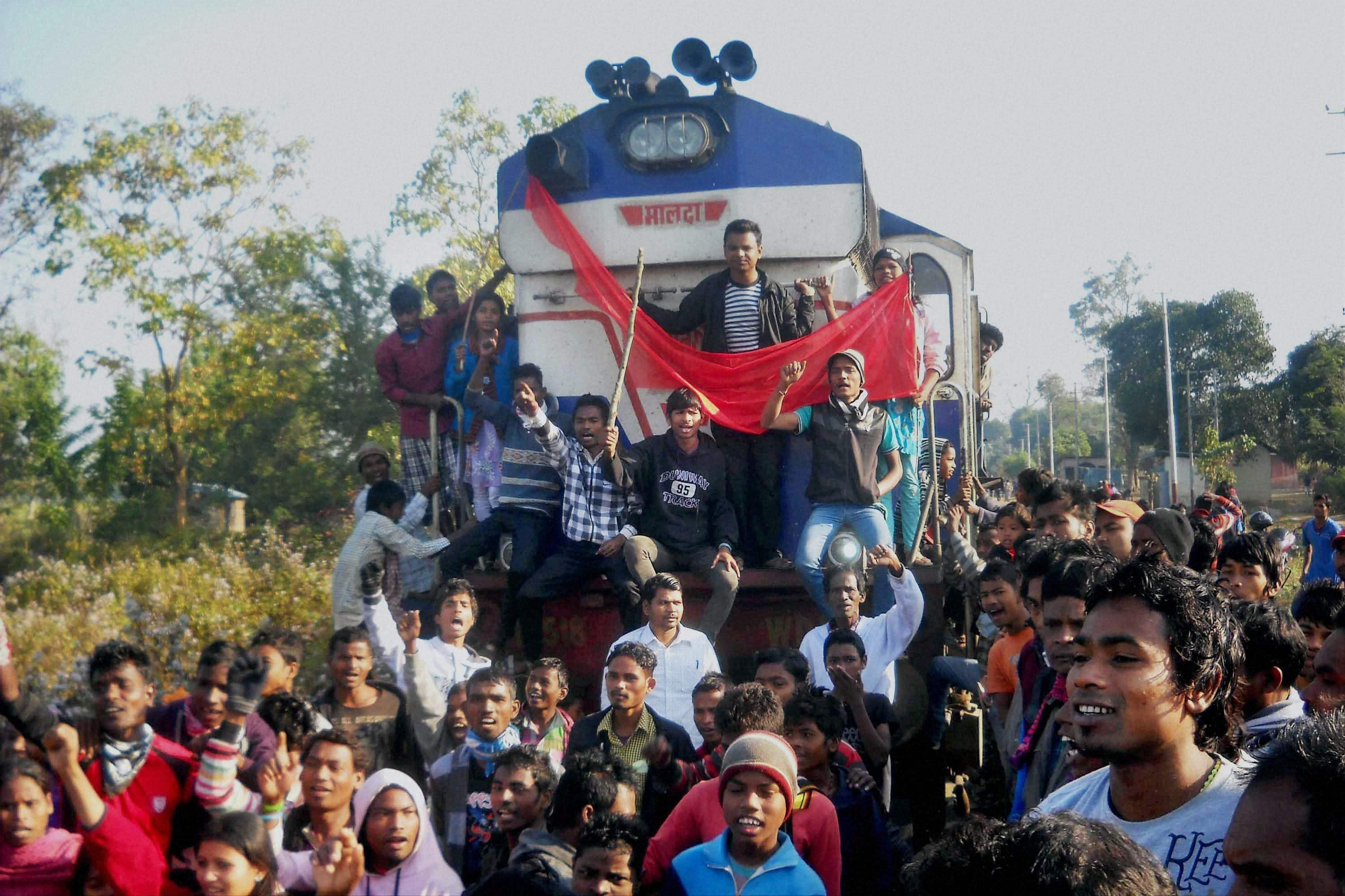 Activist of All Assam tea tribe student association stop a train at Salina Railway Station in Nagaon Dist during the 12 hr Assam Bandh called by different Adivasi Organization against the Bodo militant attacks.