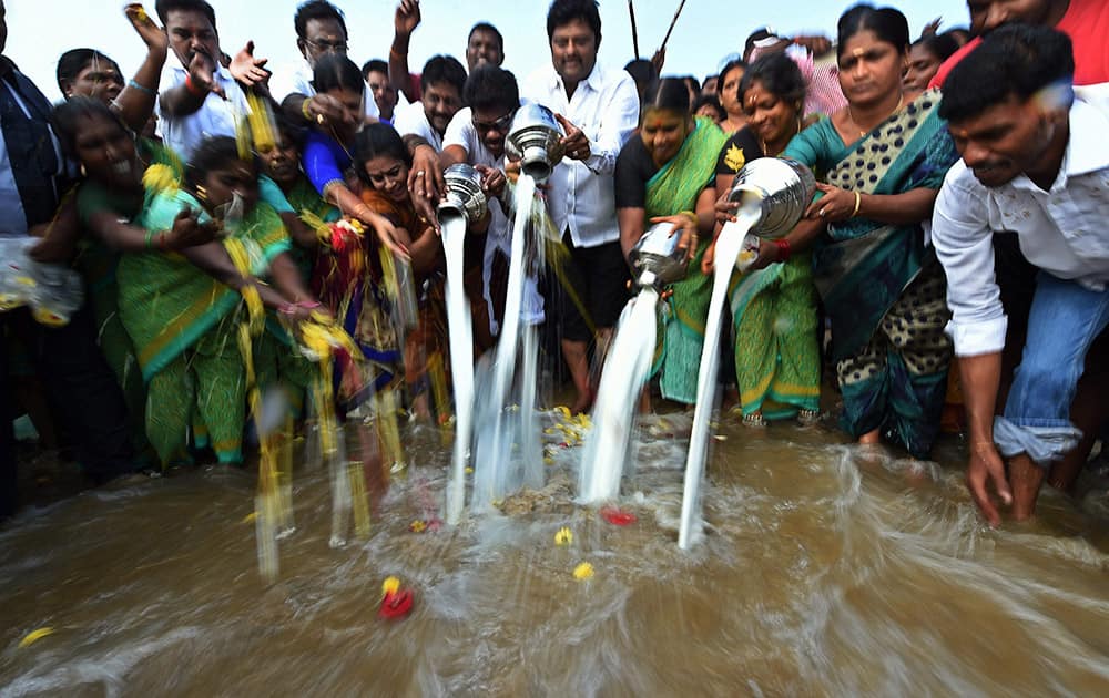 Fishermen pour milk into the sea to mark the 10th anniversary of Tsunami at Marina beach.