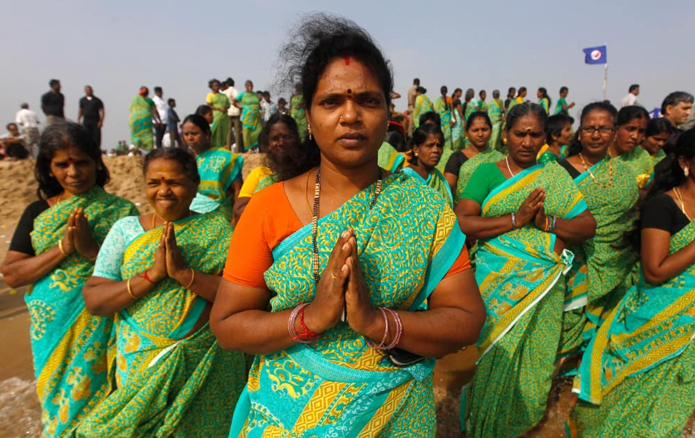 Women offer prayers on the Marina Beach at the Bay of Bengal to commemorate the 10th anniversary of the 2004 Tsunami in Chennai.