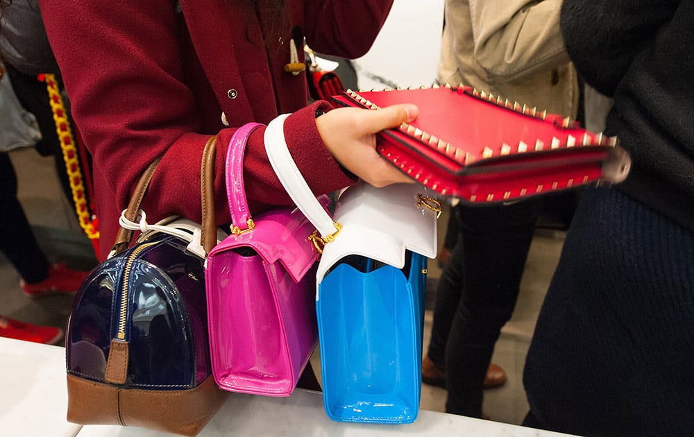 A woman shops for discounted handbags in a department store, during the Boxing Day sales, in London.