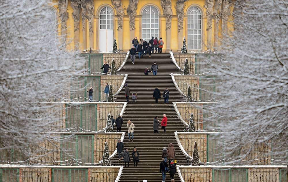 Visitors climb the outside stairway at Sanssouci palace in Potsdam. eastern Germany. Weather forecasts predict snowfall for the next few days in Germany.