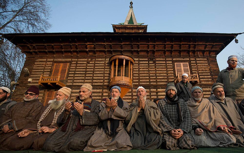 Kashmiri Muslims pray outside the Shrine of Sufi saint Khwaja Naqashbandi in Srinagar.