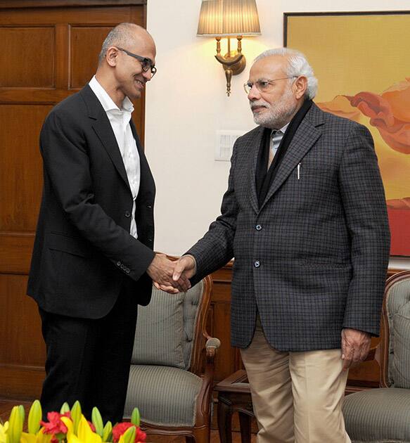 Prime Minister Narendra Modi shakes hands with CEO, Microsoft, Satya Nadella in New Delhi.