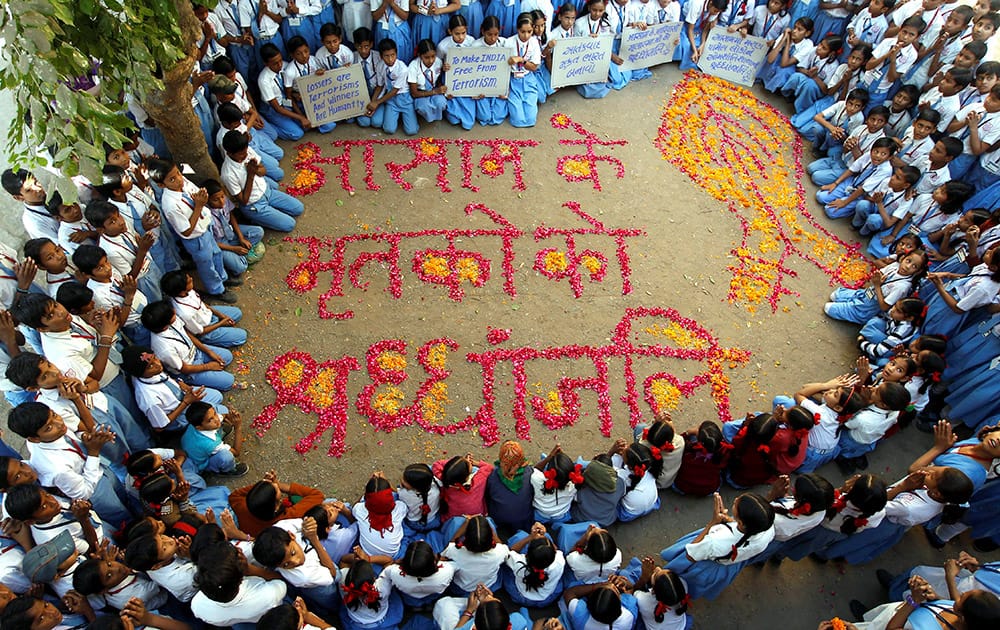 Students pay homage to victims of Tsunami on the 10th anniversary and tribal people who were killed in Assam by Bodo militants, during Special prayer in side school in Ahmedabad.