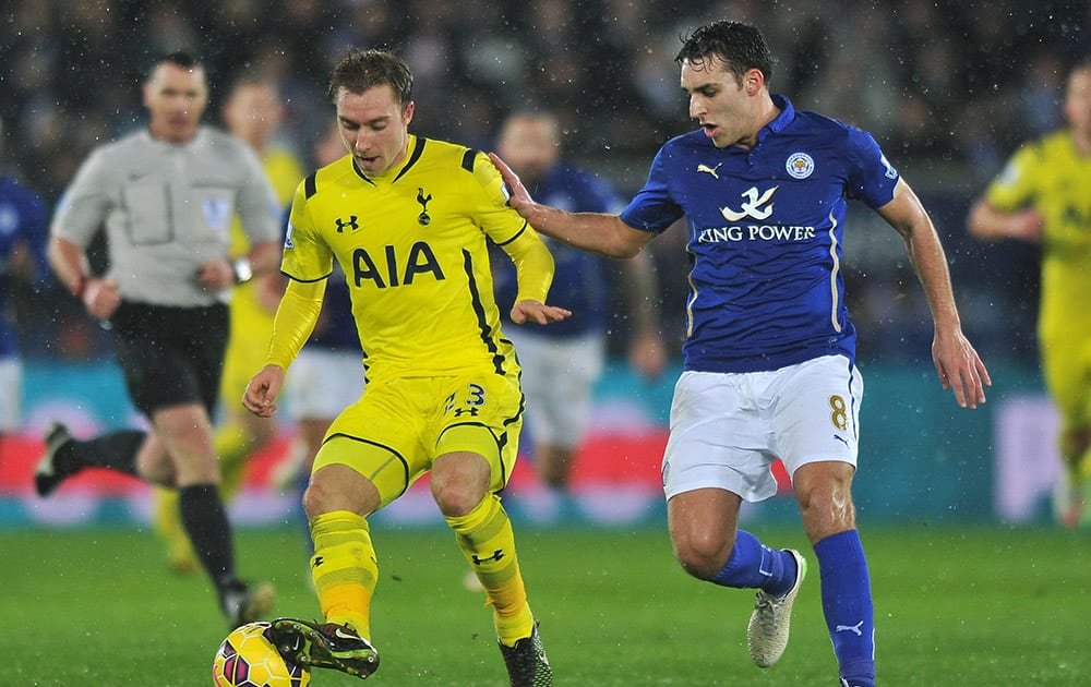 Tottenham Hotspur's Christian Eriksen and Leicester City's Matty James battle for the ball during the English Premier League soccer match at the King Power Stadium, Leicester, England.