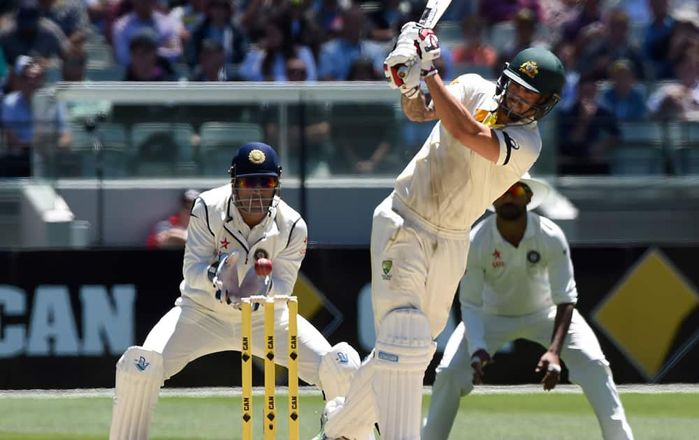 Australia's Mitchell Johnson, plays at a ball and misses allowing India's wicketkeeper MS Dhoni, to stump him for 28 runs on the second day of their cricket test match in Melbourne, Australia.