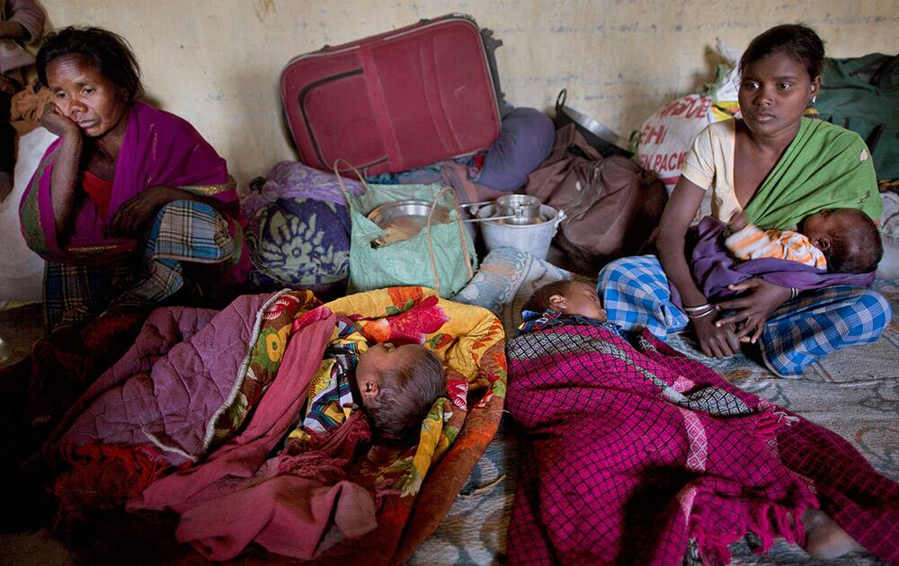 Tribal settlers take refuge in a local school after their village was attacked by an indigenous separatist group called the National Democratic Front of Bodoland, in Shamukjuli village in Sonitpur district of Indian eastern state of Assam.