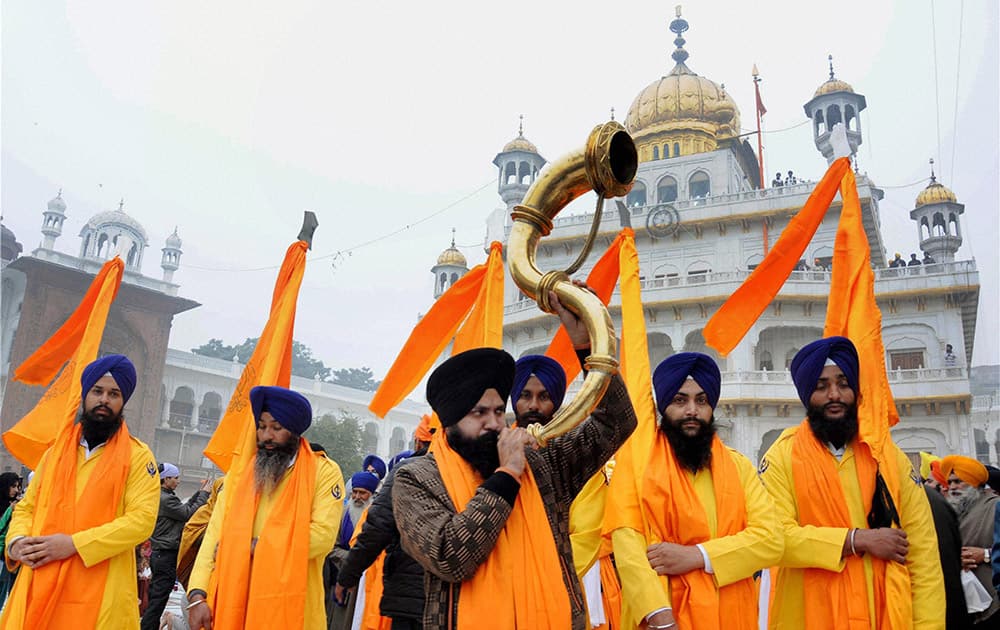 Panj Pyare members during a religious procession at the Golden Temple on the eve of birth anniversary of Guru Gobind Singh, in Amritsar.