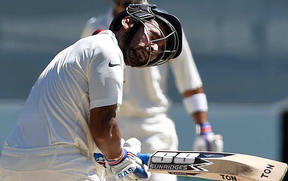 India's Murali Vijay is hit in the head by a bouncer from Australia's Mitchell Johnson on the third day of their cricket test match in Melbourne, Australia.