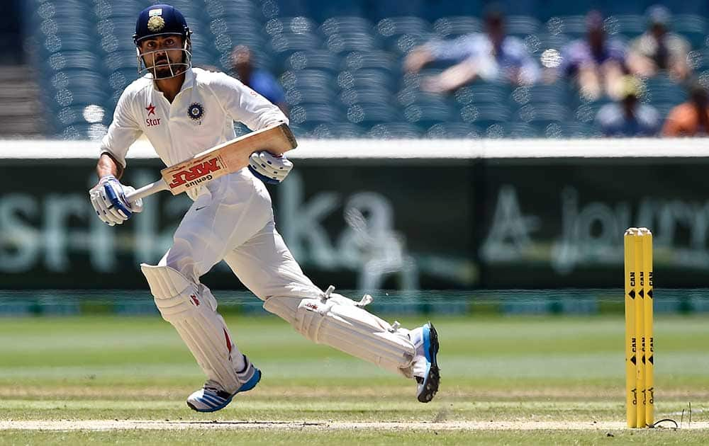 India's Virat Kohli makes runs after playing a shot on the third day of their cricket test match against Australia in Melbourne, Australia.