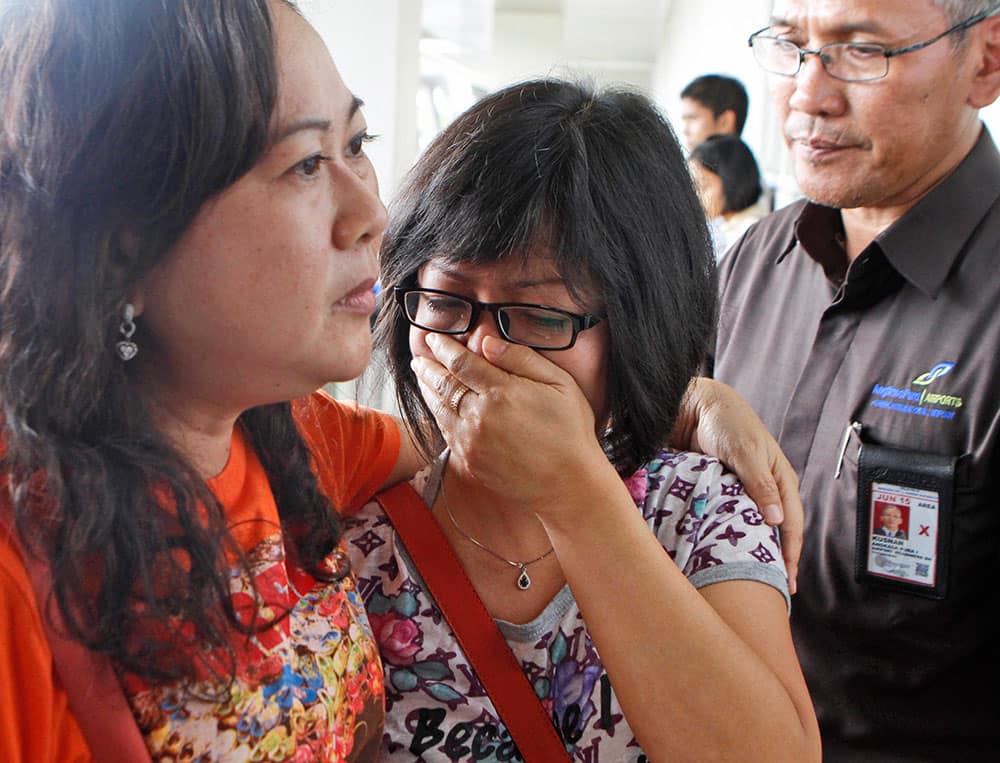 A relative of Air Asia flight QZ8501 passengers weep as she waits for the latest news on the missing jetliner at Juanda International Airport in Surabaya, East Java, Indonesia.