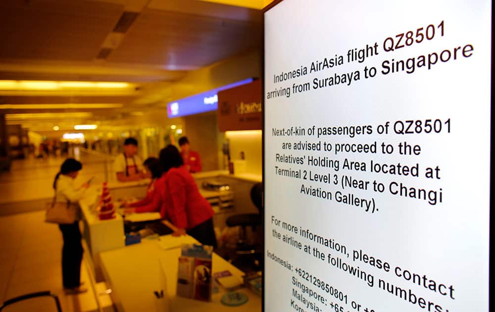 Electronic sign boards instructing relatives and next-of-kin to gather at a holding area are placed in various places at the Changi International Airport where AirAsia flight QZ8501 from Surabaya was scheduled to land.