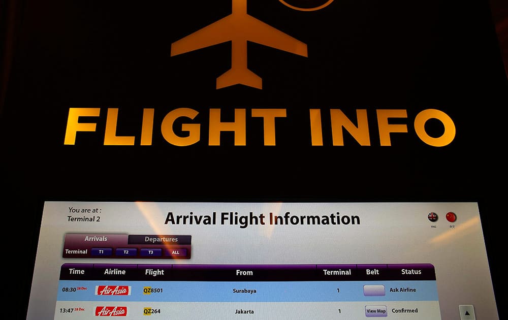 An electronic kiosk providing flight information shows the status for AirAsia flight QZ8501 from Surabaya to Singapore as 