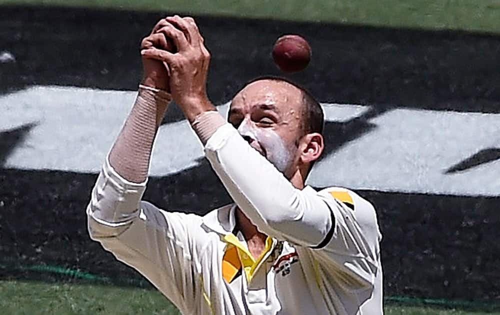 Australia's Nathan Lyon can not catch the ball hit by India's Ajinkya Rahane on the third day of their cricket test match in Melbourne, Australia.