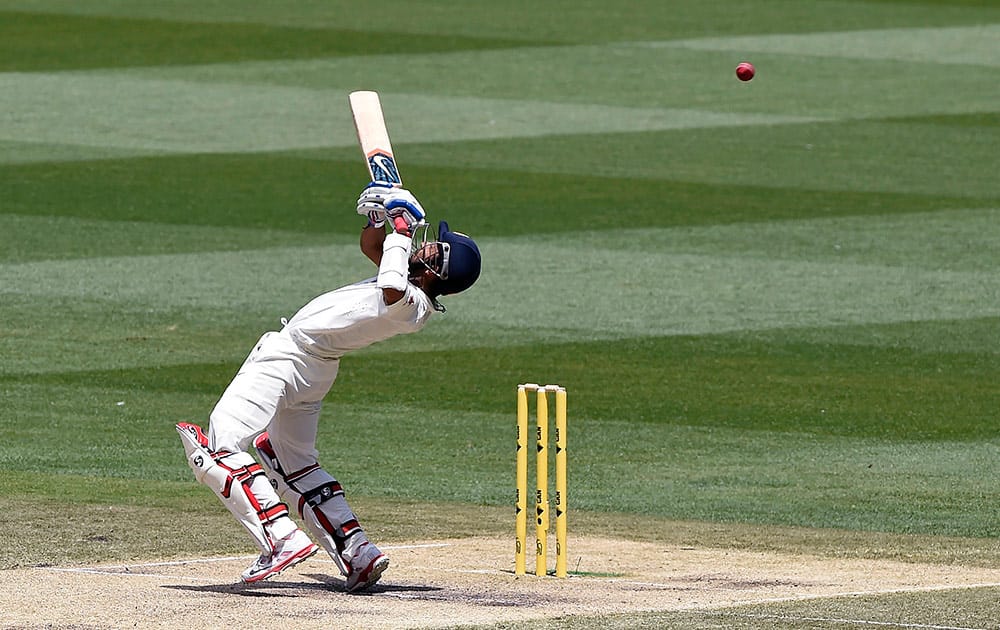 India's Ajinkya Rahane bends backward to avoid a high delivery on the third day of their cricket test match against Australia in Melbourne, Australia.