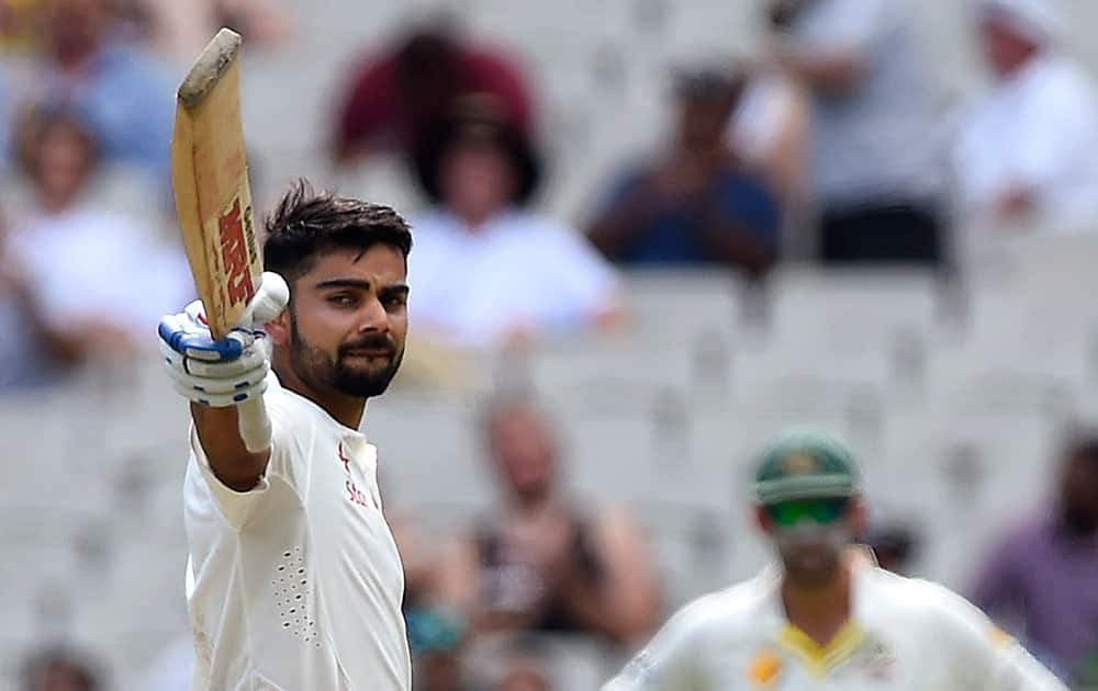 India's Virat Kohli raises his bat after making 150 runs against Australia on the third day of their cricket test match against Australia in Melbourne, Australia.