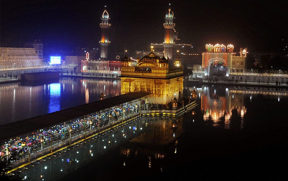 A view of spectacularly illuminated Golden Temple on the eve of birth anniversary of Guru Gobind Singh, in Amritsar.