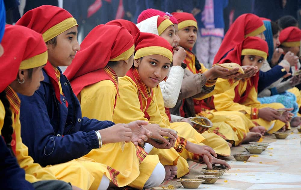 School students during langar on the occasion of birth anniversary of Guru Gobind Singh, at Golden Temple.