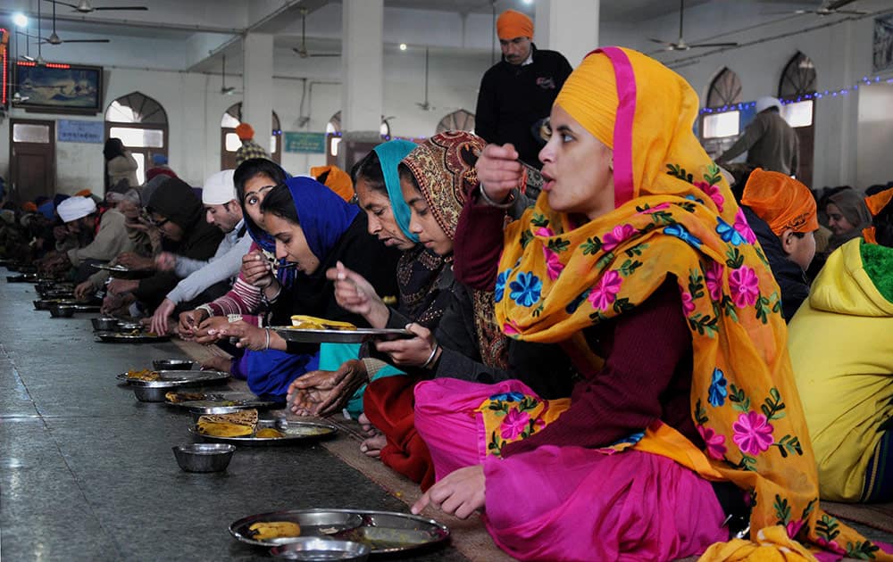 Devotees during langar on the occasion of birth anniversary of Guru Gobind Singh, at Golden Temple.