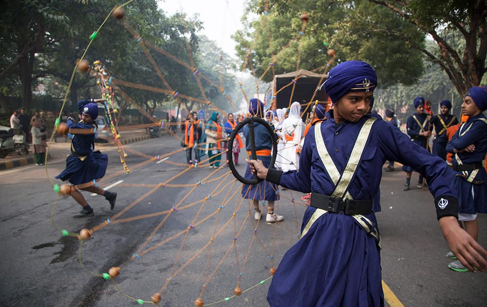 An Indian Sikh boy displays his martial art skills during a religious procession to mark the birth anniversary of Guru Gobind Singh, the tenth Sikh guru, in New Delhi.