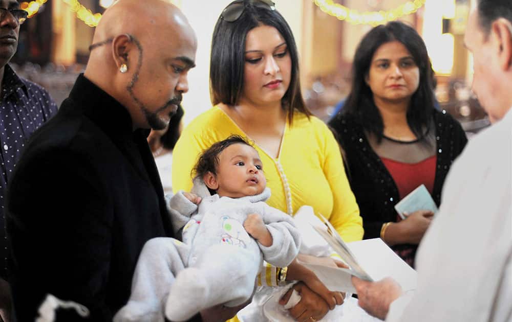 Former cricketer Vinod Kambli with his wife Andrea Hewitt during baptism of their daughter at a Church in Mumbai.