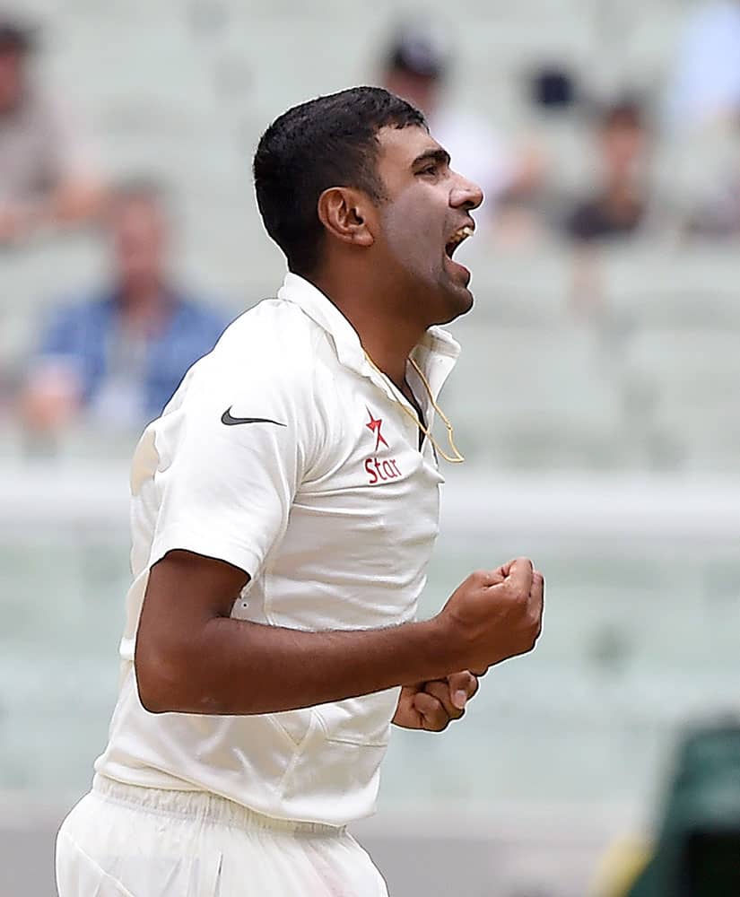India's Ravichandran Ashwin celebrates trapping Australia's David Warner LBW for 40 runs on the fourth day of their cricket test match in Melbourne, Australia.